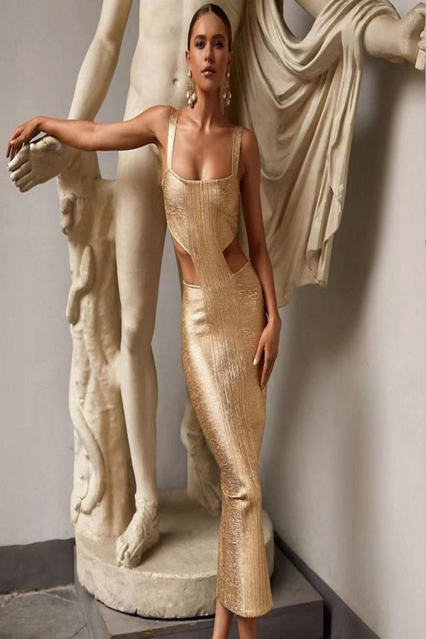 Woman in a gold dress standing next to classical statues